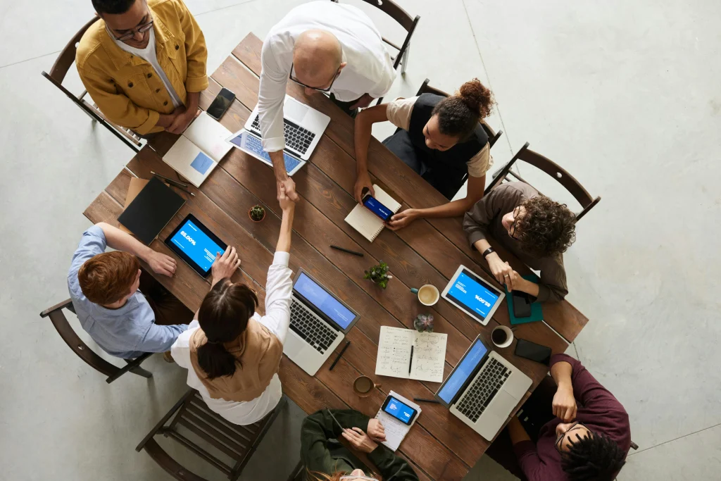 Web design team in Rivonia working together at a desk with a bunch of laptops on it