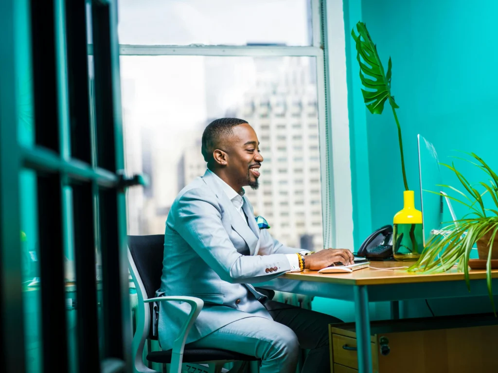 a Fairland web design smiling while working at his desk